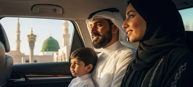 Saudi family in a private car looking out the window at the Prophet's Mosque Al-Masjid an-Nabawi in Madinah.