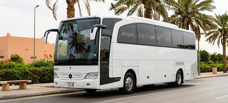 White Mercedes luxury coach available for private group transport and transfers in Dammam.